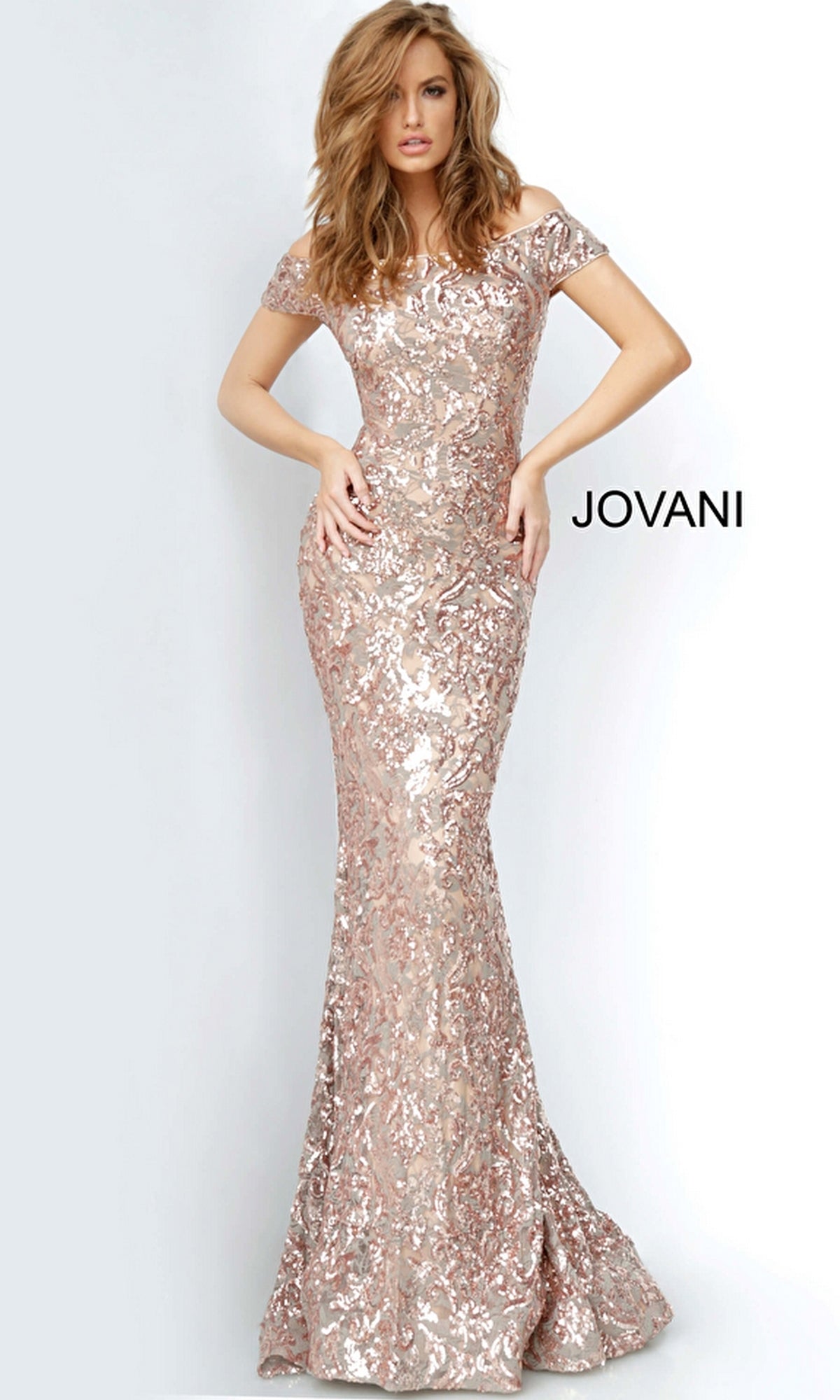 A woman models the Off-Shoulder Jovani Long Beaded Formal Dress 1122, a floor-length rose gold sequin gown perfect for prom, while standing against a plain background.